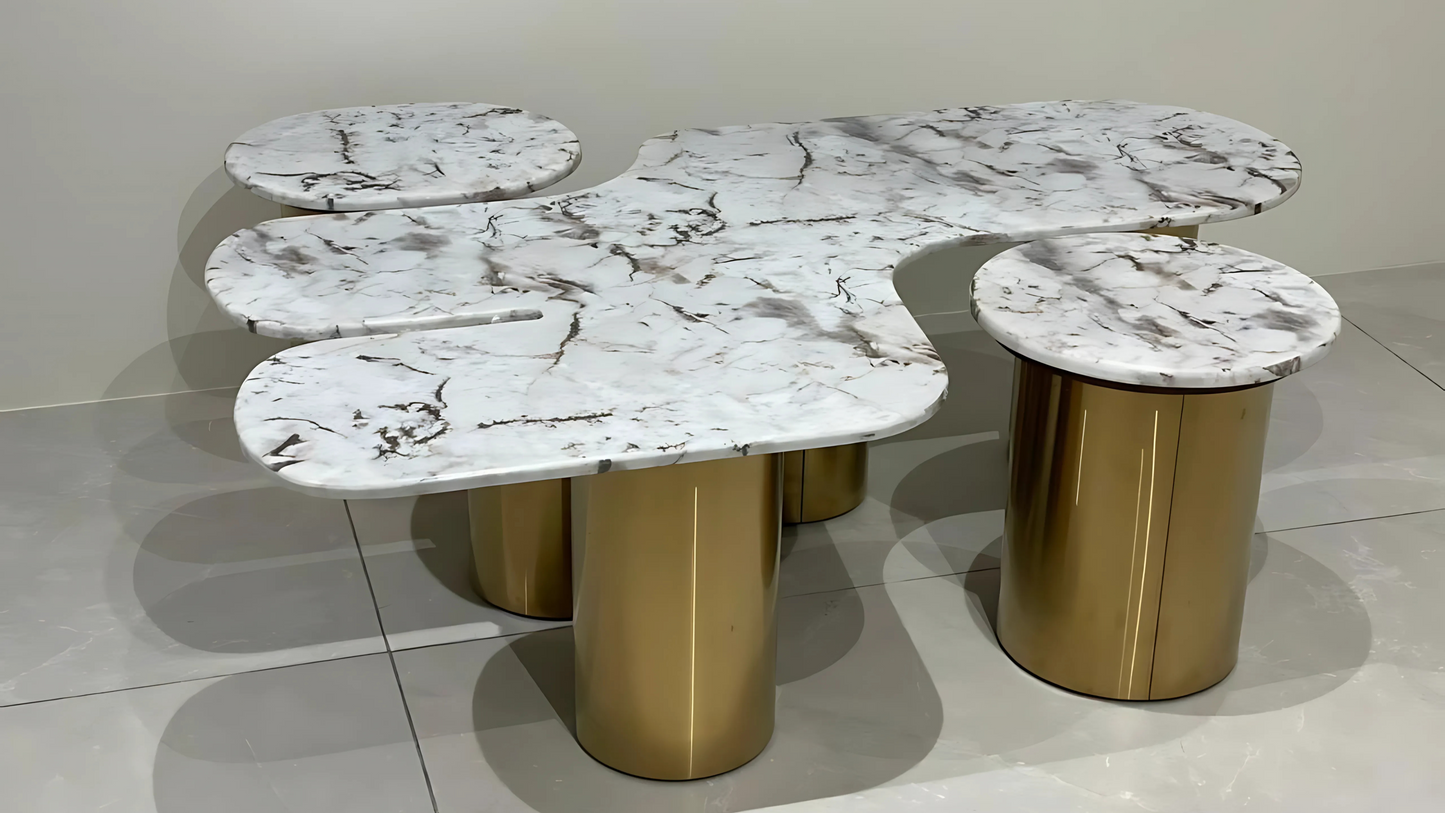 Luxury sculptural center table with organic white marble tops and gold cylindrical legs