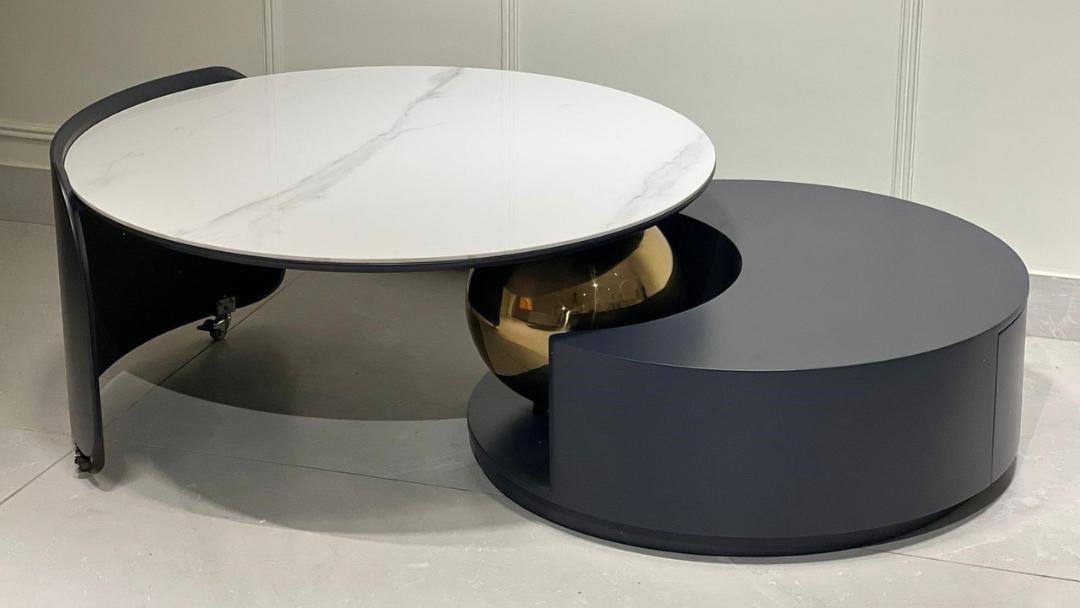 Circular marble coffee table with gold sphere and graphite base