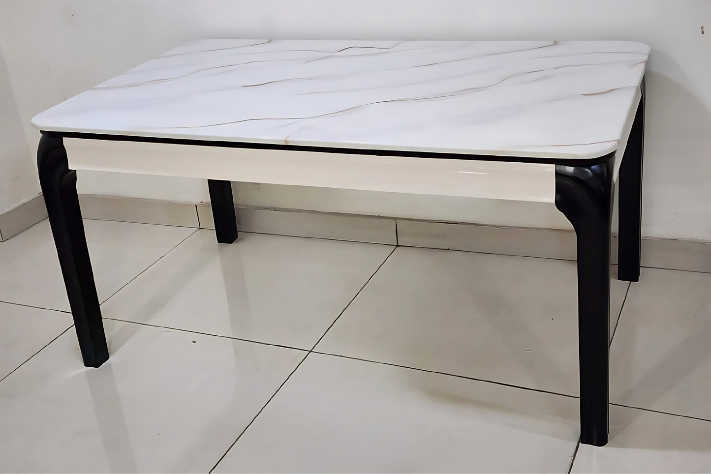 Modern white dining table with soft wave-textured marble top and black matte legs in minimalist design
