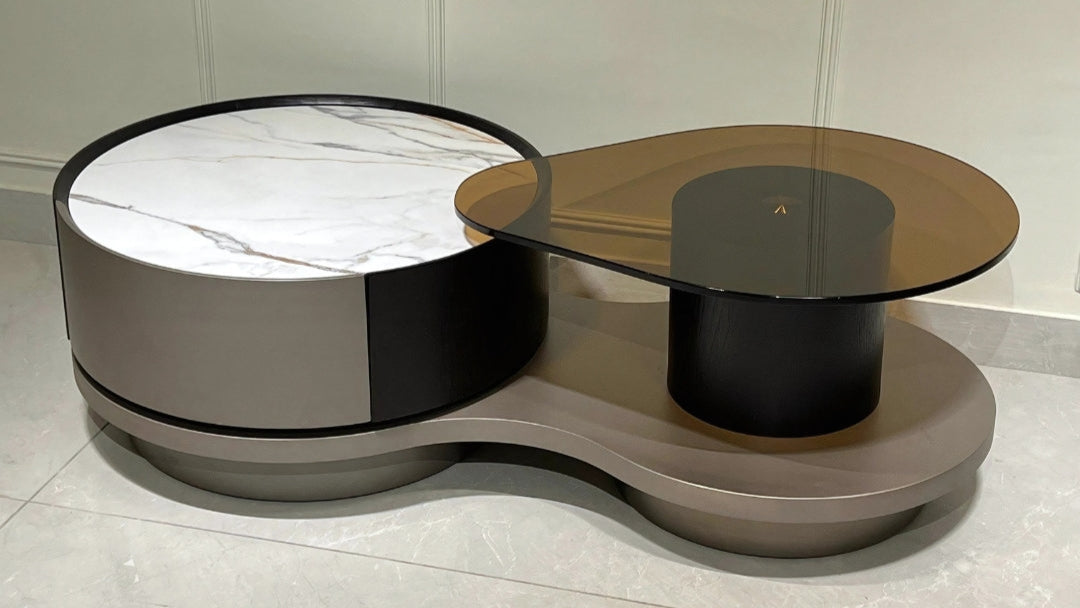 Modern round marble center coffee tables with chrome ribbed bases in grey and white tones
