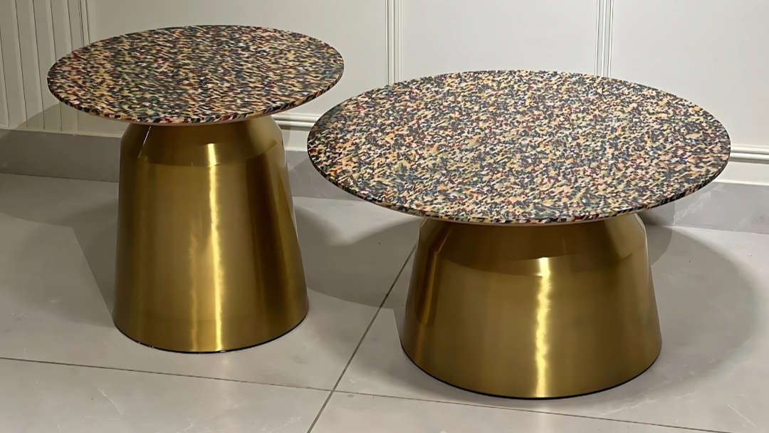 Aurora Spectrum brass pedestal base center coffee table with terrazzo-inspired top.