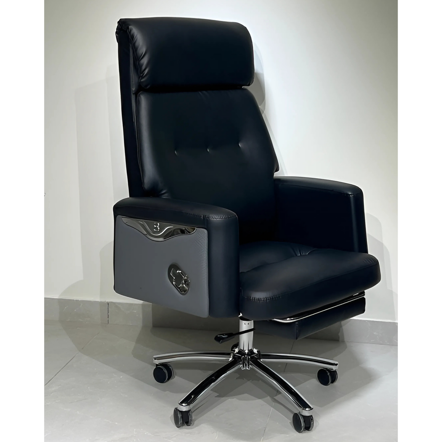 A black leather office chair with a high back, footrest, and a metal base.