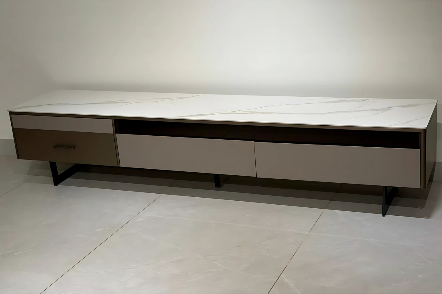 Modern TV stand with marble-like top and wooden sides on a tiled floor.