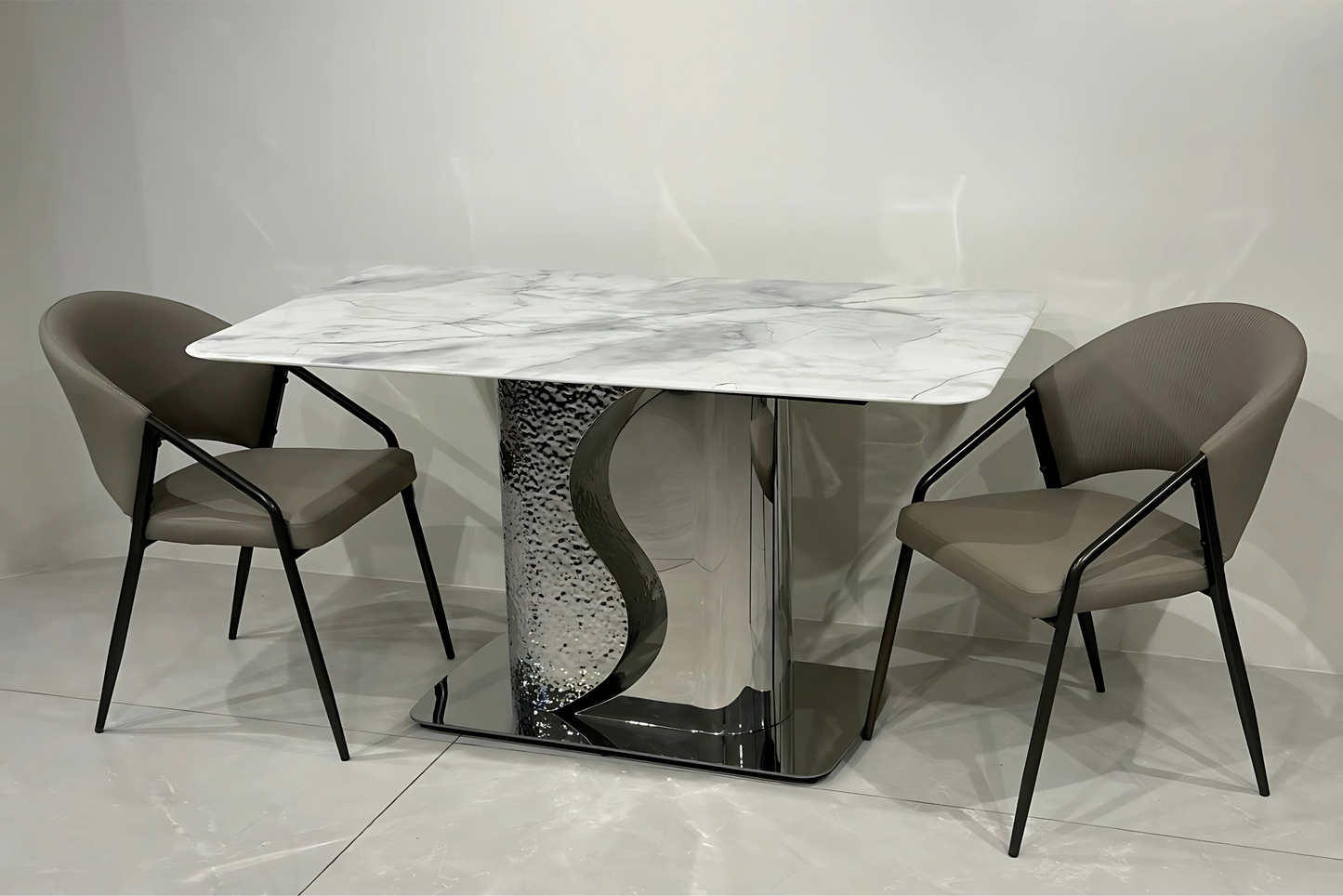 White marble dining table with chrome wave base and taupe black-framed chairs in luxury modern style.