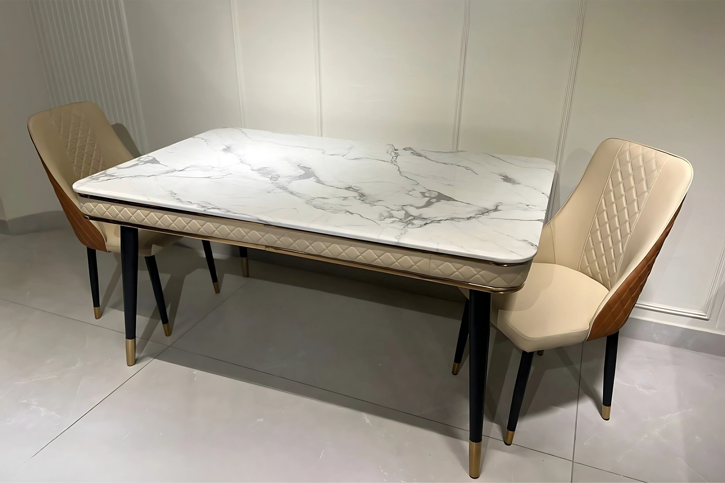 Luxury dining table with quilted beige apron, white marble top, and gold-detailed black legs