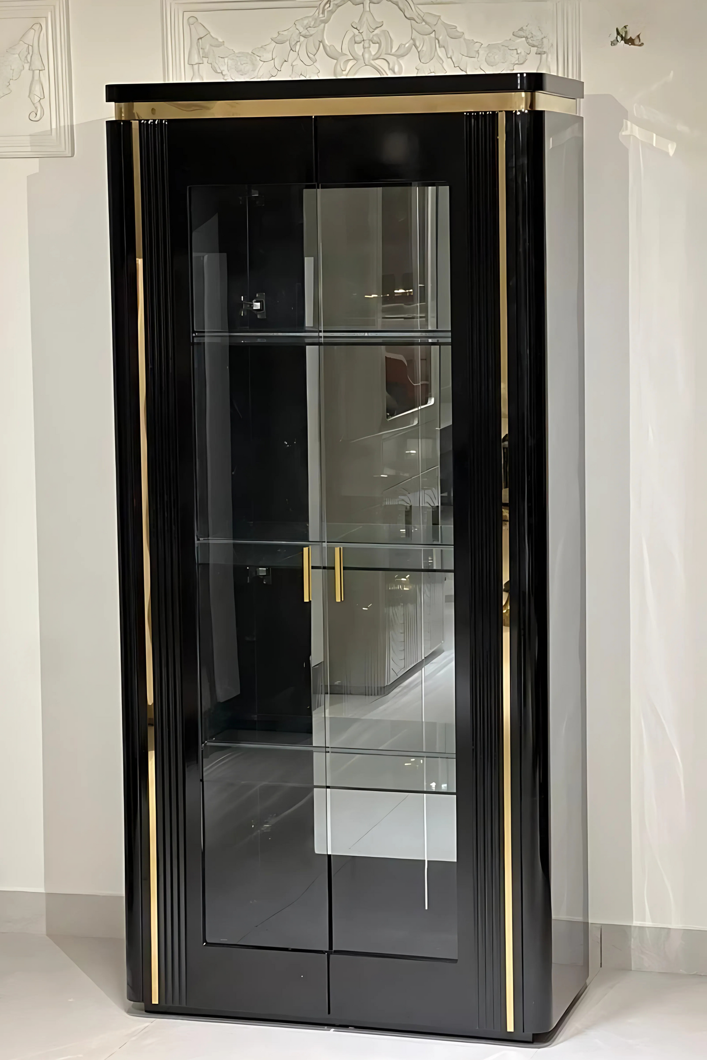 Elegant black display cabinet with glass doors and gold trim, featuring interior shelving.