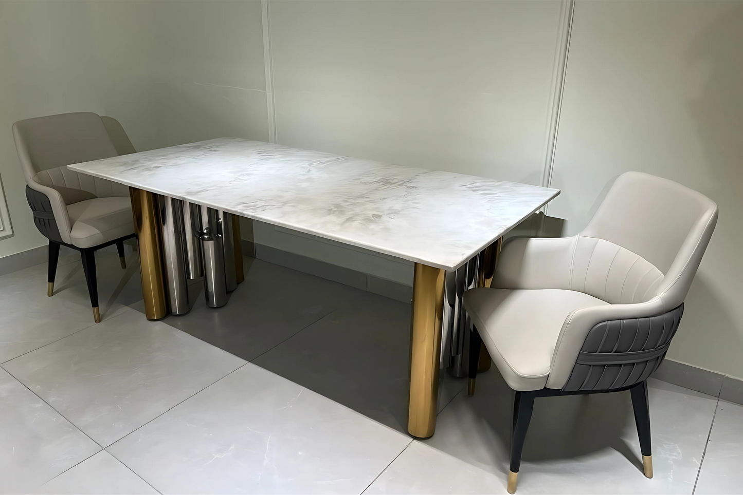 A modern rectangular dining table with a white marble surface, surrounded by 2 chairs with beige and gray upholstery.