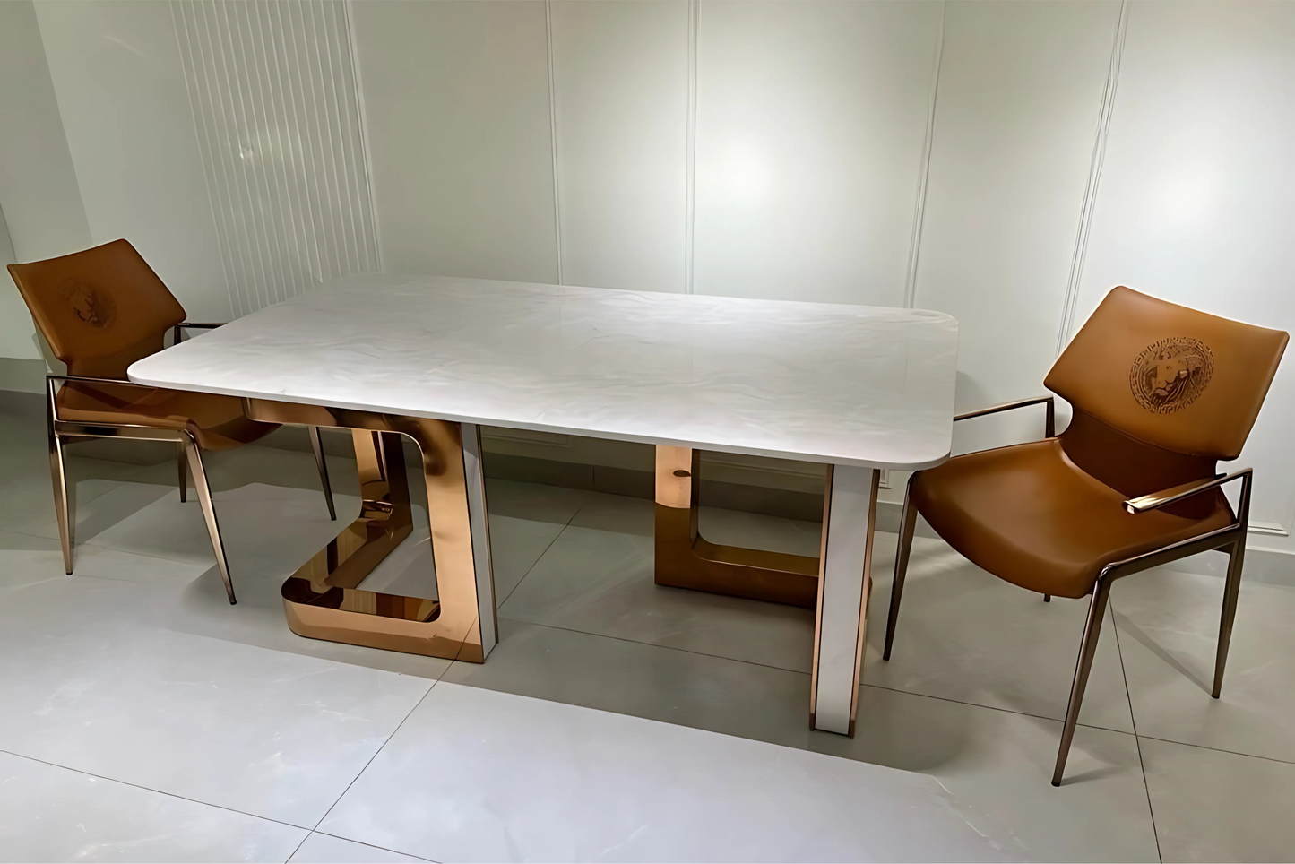 Modern luxury dining table with matte white top and rose-bronze sculptural pedestal legs