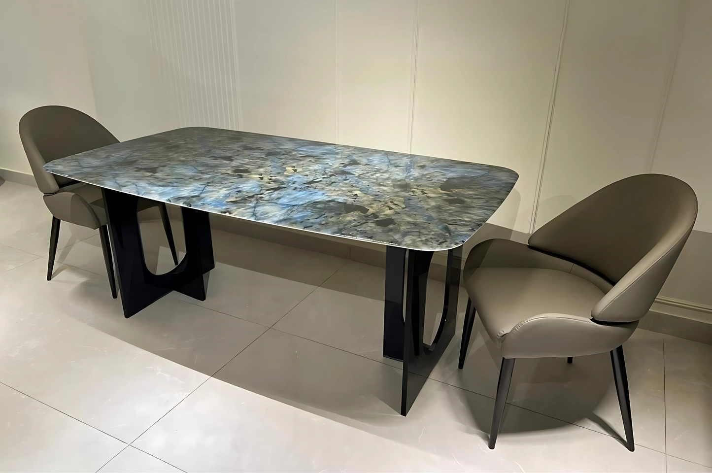 Luxury blue quartzite dining table with sculptural black metal base and taupe leatherette chairs