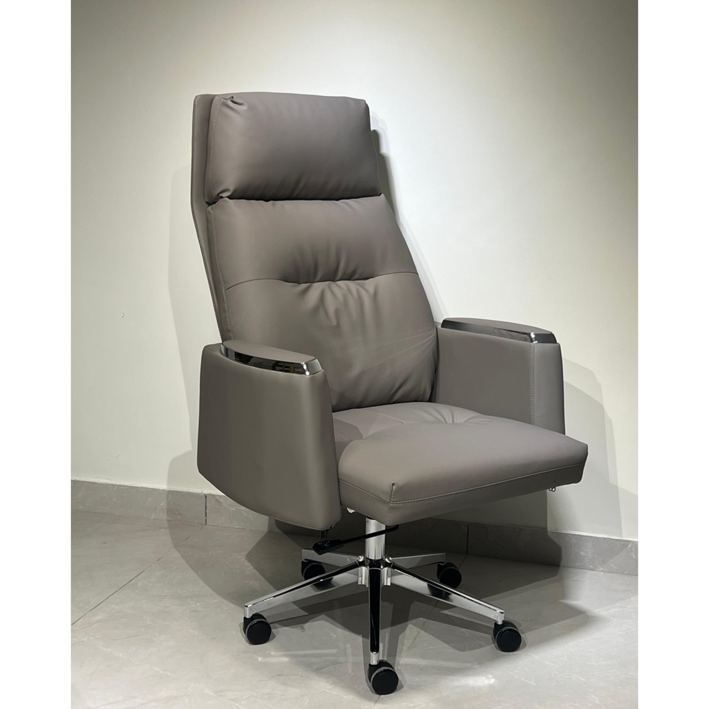A gray office chair with high back, armrests, and a five-point wheeled base.