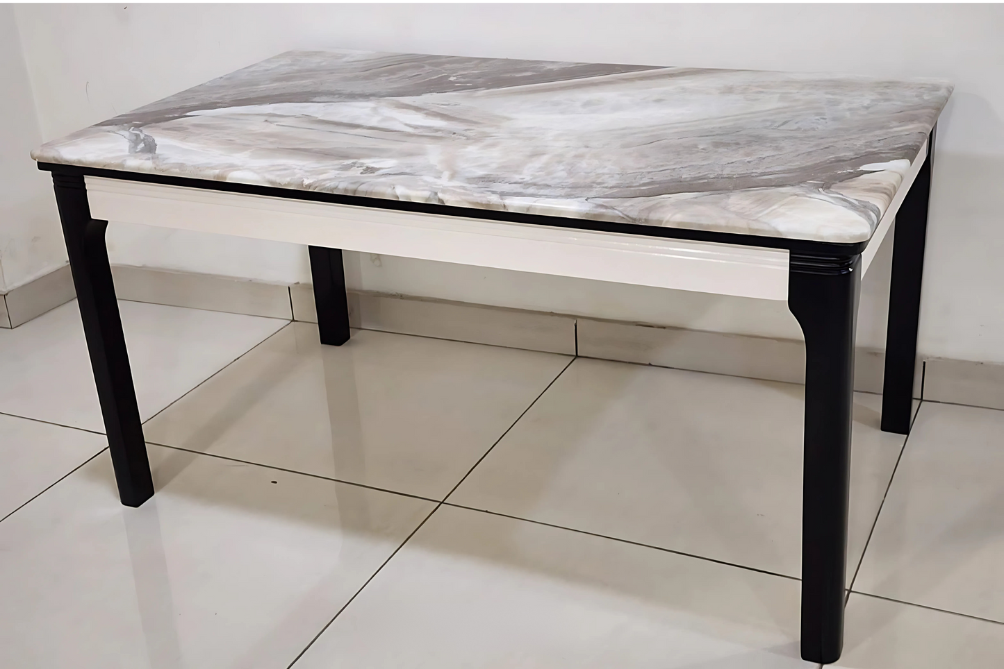 Dining table with flowing grey marble top, ivory apron, and black wooden legs