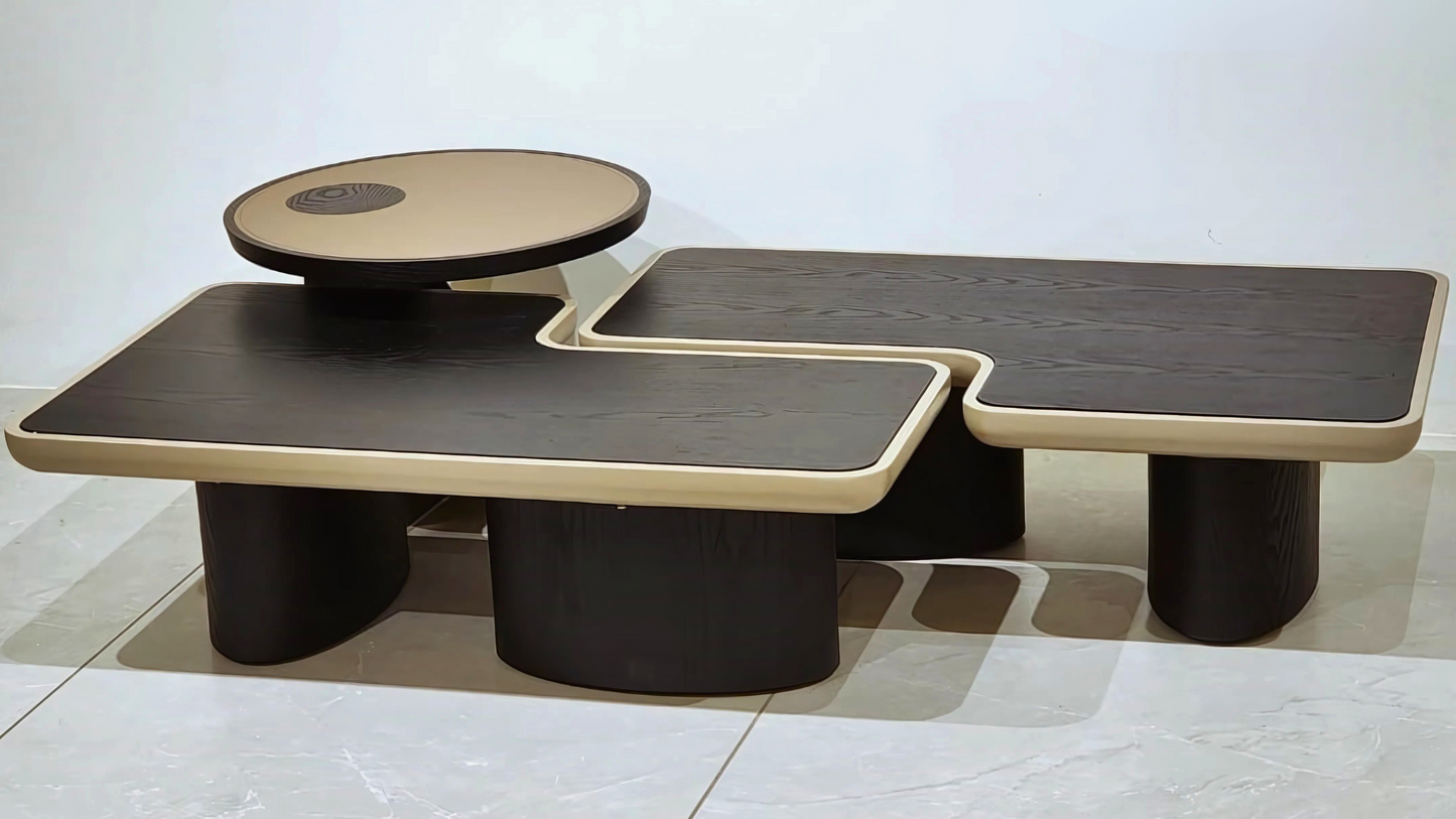 Three-piece black and beige modern sculptural center coffee table with curved modular design