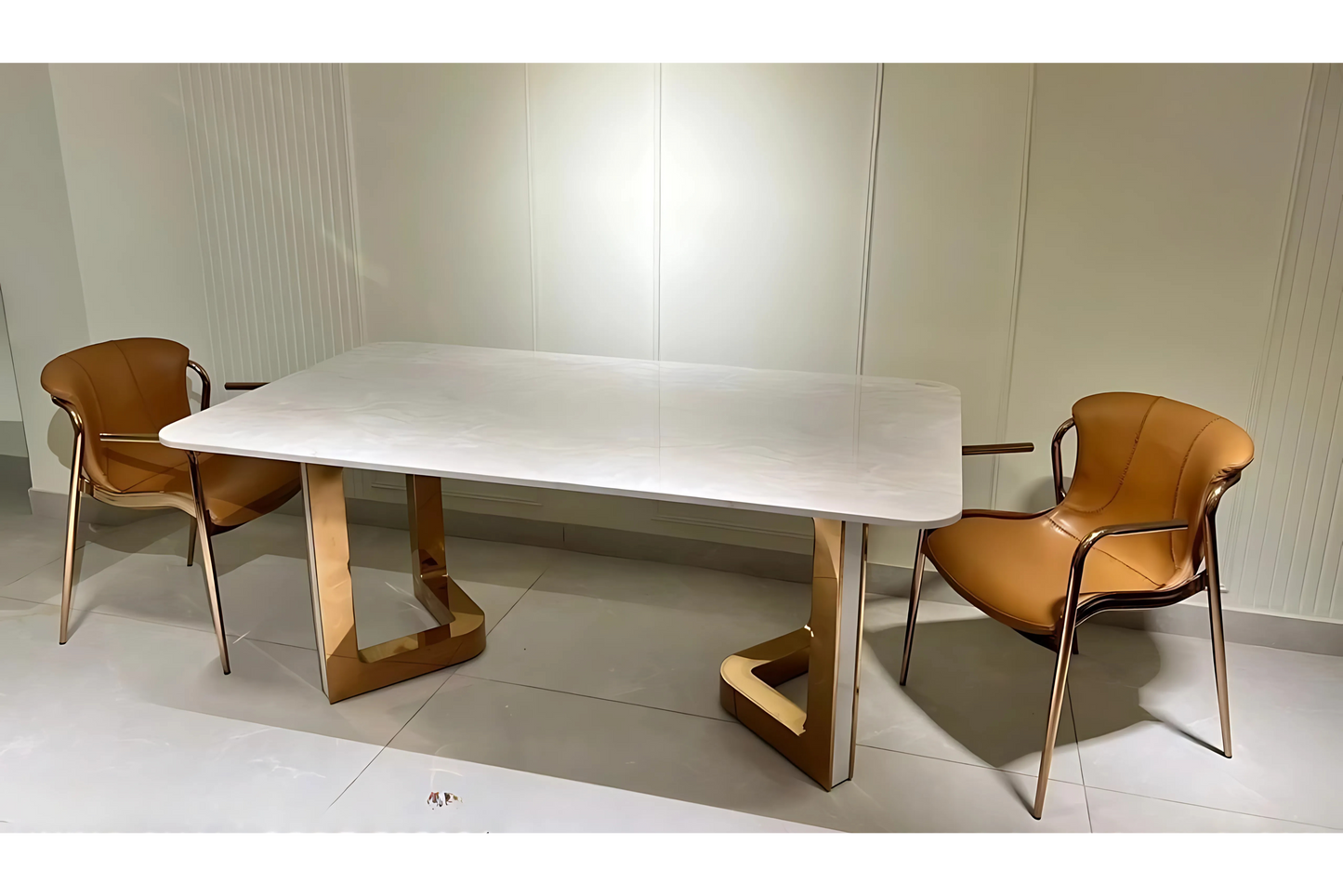 A modern dining table with a white marble surface, accompanied by two brown chairs with a metal frame.