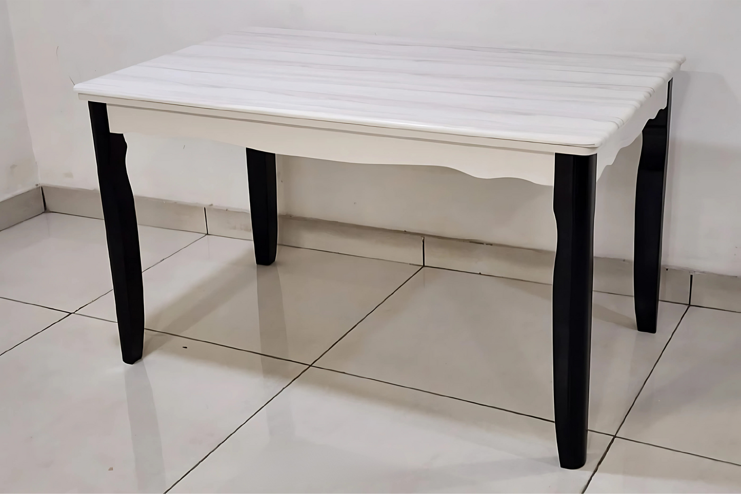 White marble-effect dining table with sculpted apron and matte black tapered legs