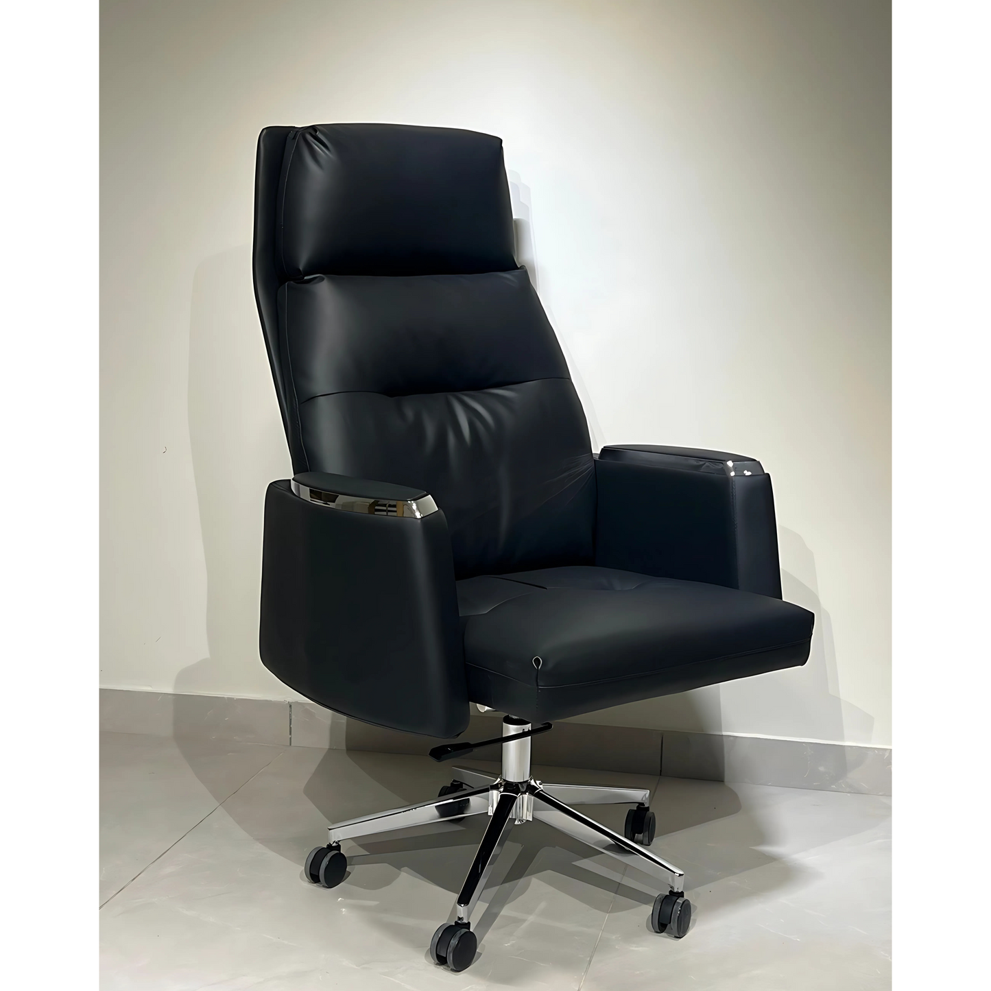 A black leather office chair with a high back, armrests, and a five-point wheeled base.