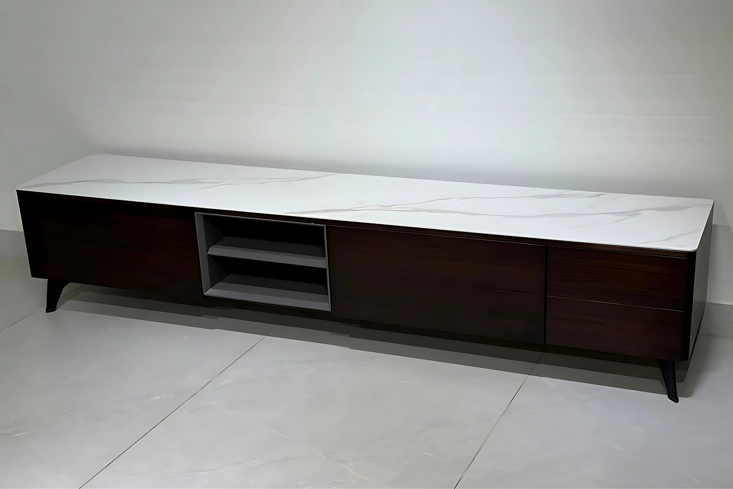 Modern TV stand with white top and dark wood base on a plain background