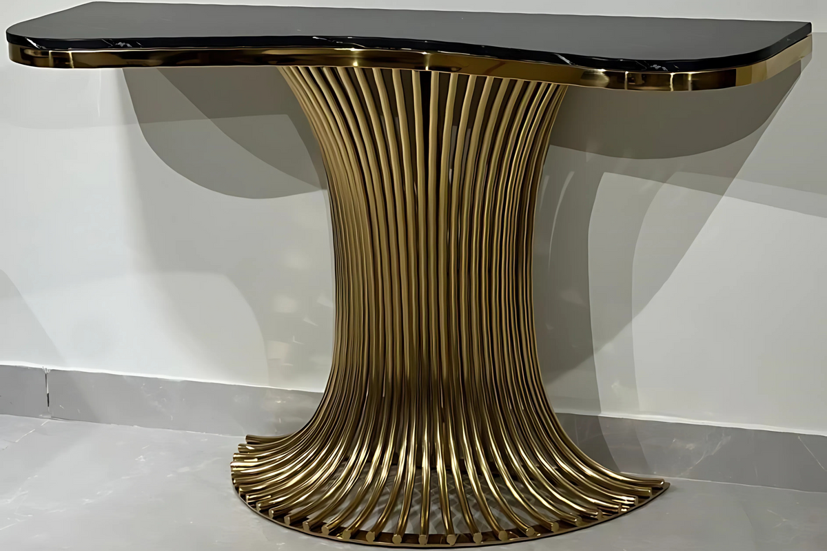 A black marble console table with a gold-finish metal base.
