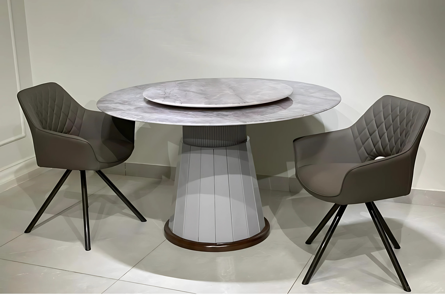 Round dining table with fluted grey pedestal base and marble Lazy Susan top in luxury modern setting