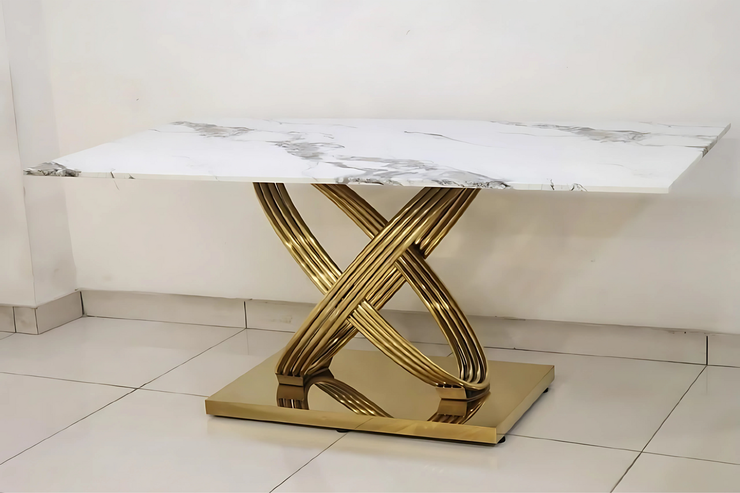 Luxury white marble dining table with interwoven gold pedestal base and modern sculptural design
