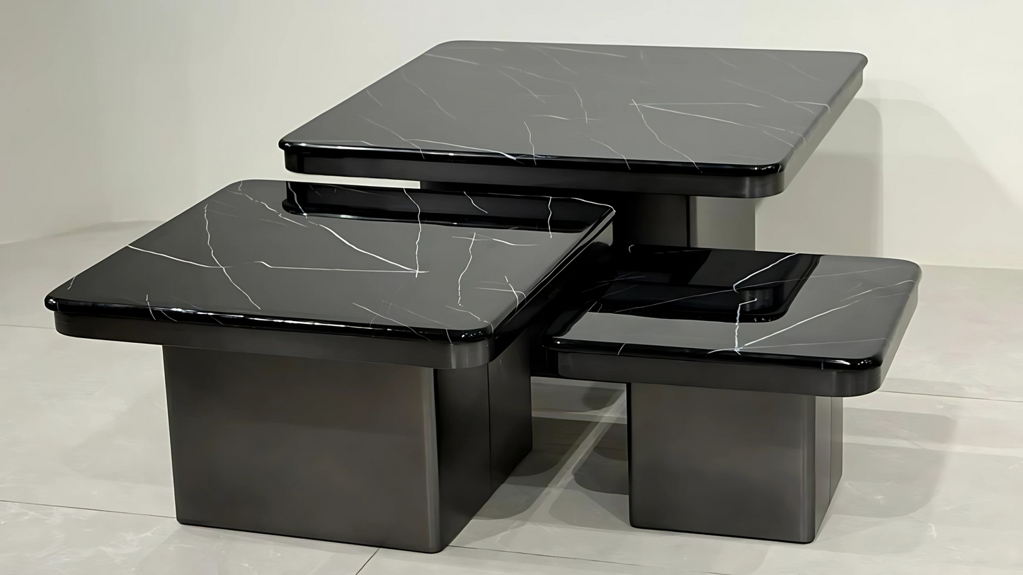 Set of three luxury black marble center coffee tables with white veining and cubic black bases in nesting form