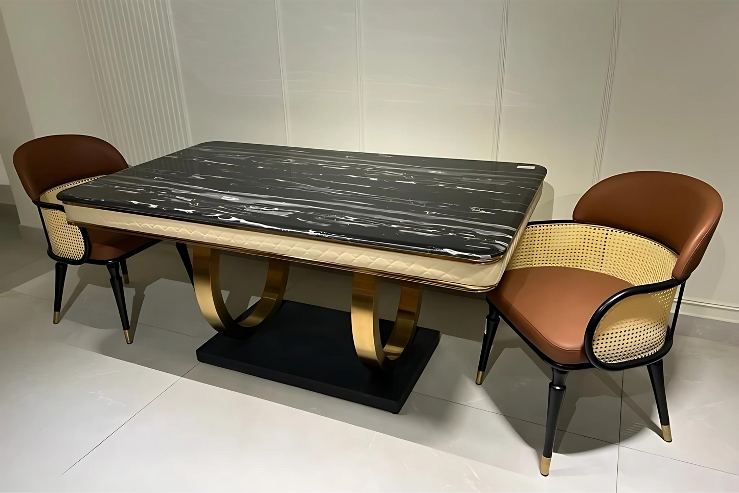 Luxury dining table with black marble top, beige quilted apron, and gold curved pedestal base