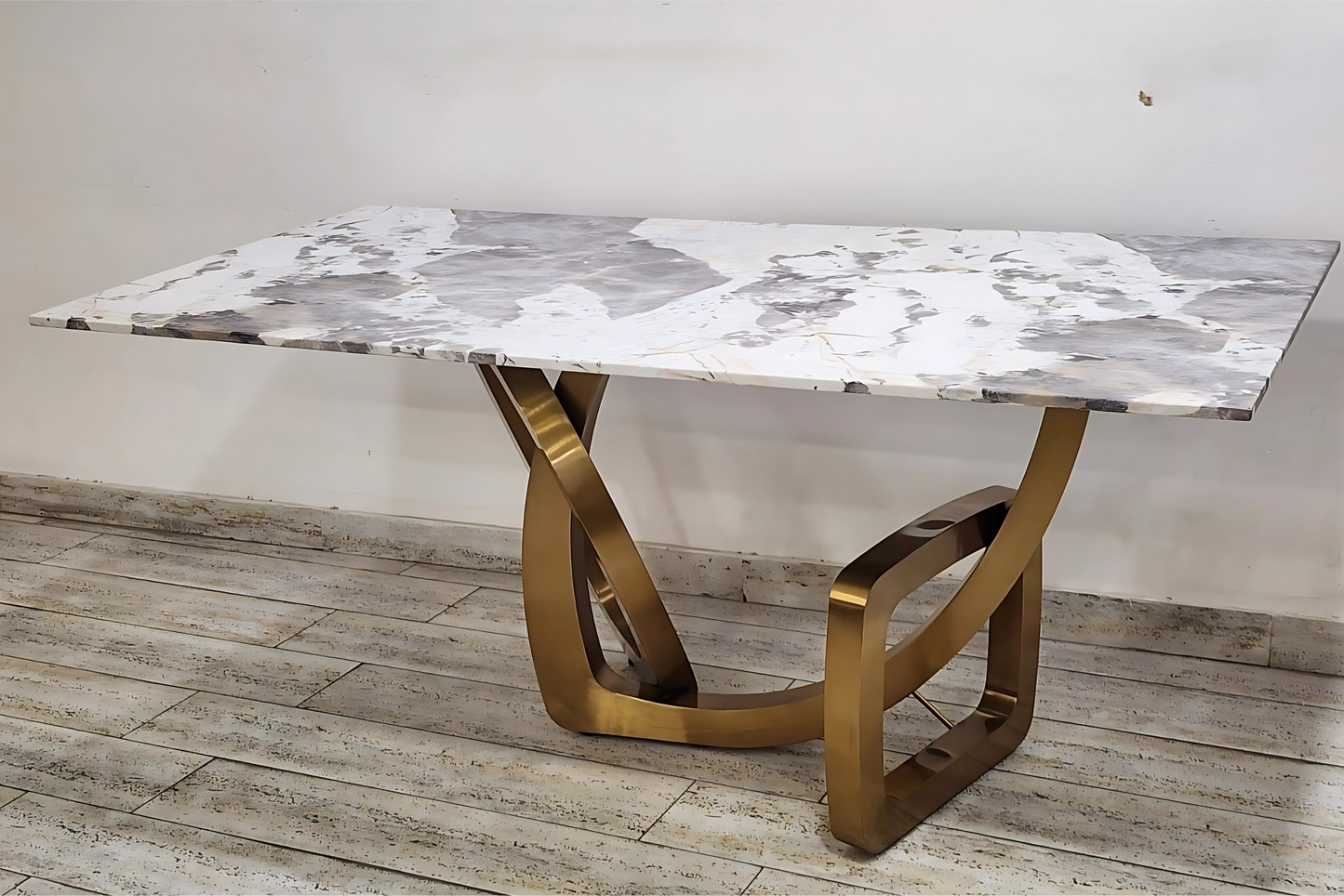 Gold-base dining table with abstract marble top and sculptural modern design
