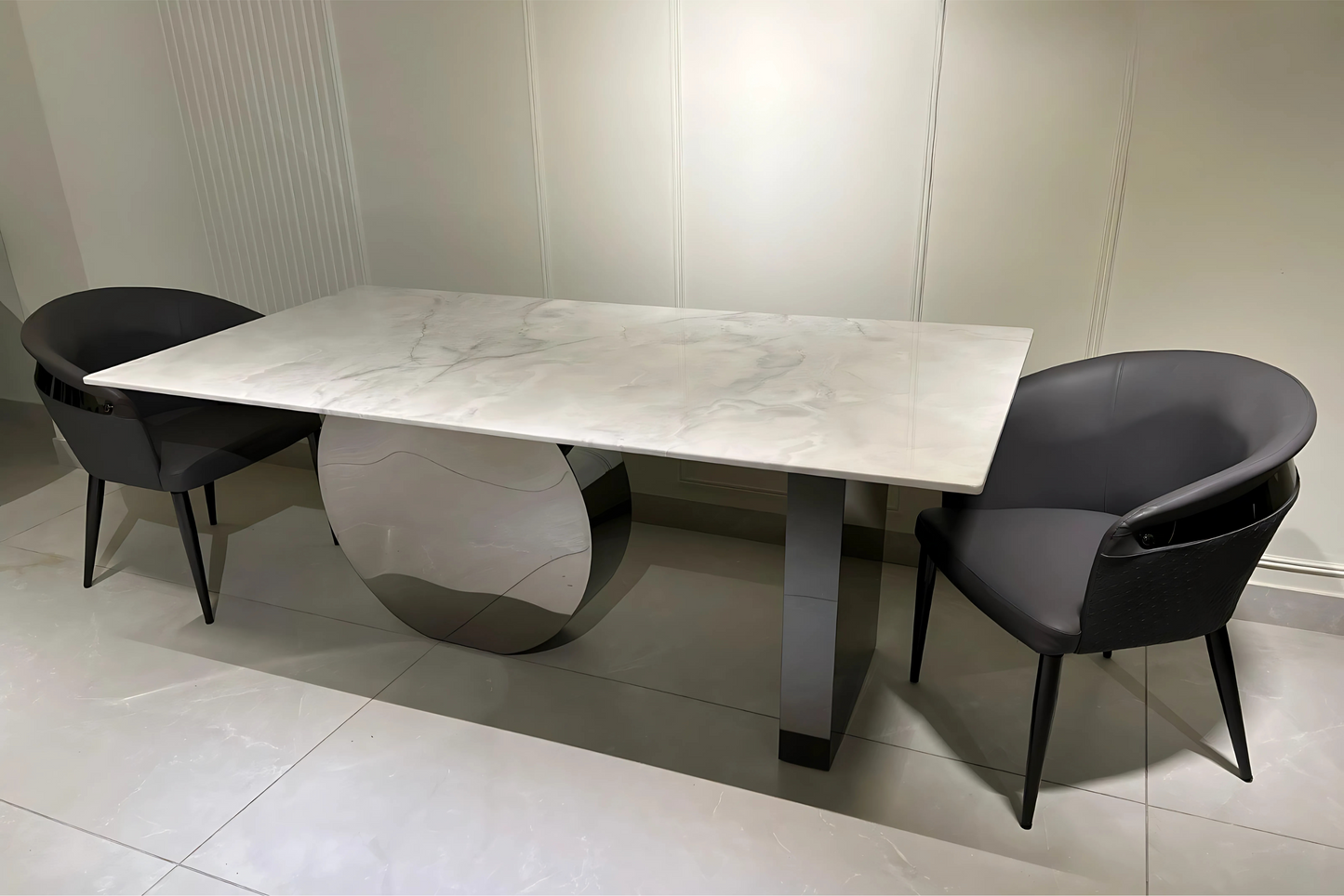 Modern dining table with marble-finish top, chrome disc base, and graphite leg