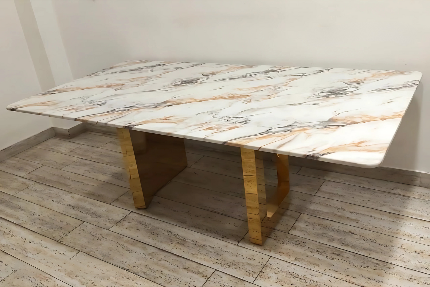 Luxury rectangular marble dining table with golden veins and gold-finished sculptural legs