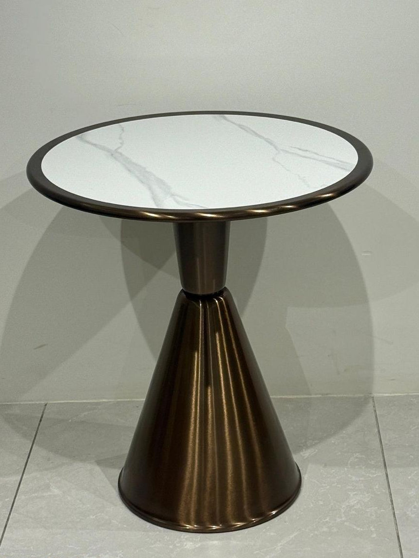 Coffee table with marble-like top and bronze base on a light gray floor.