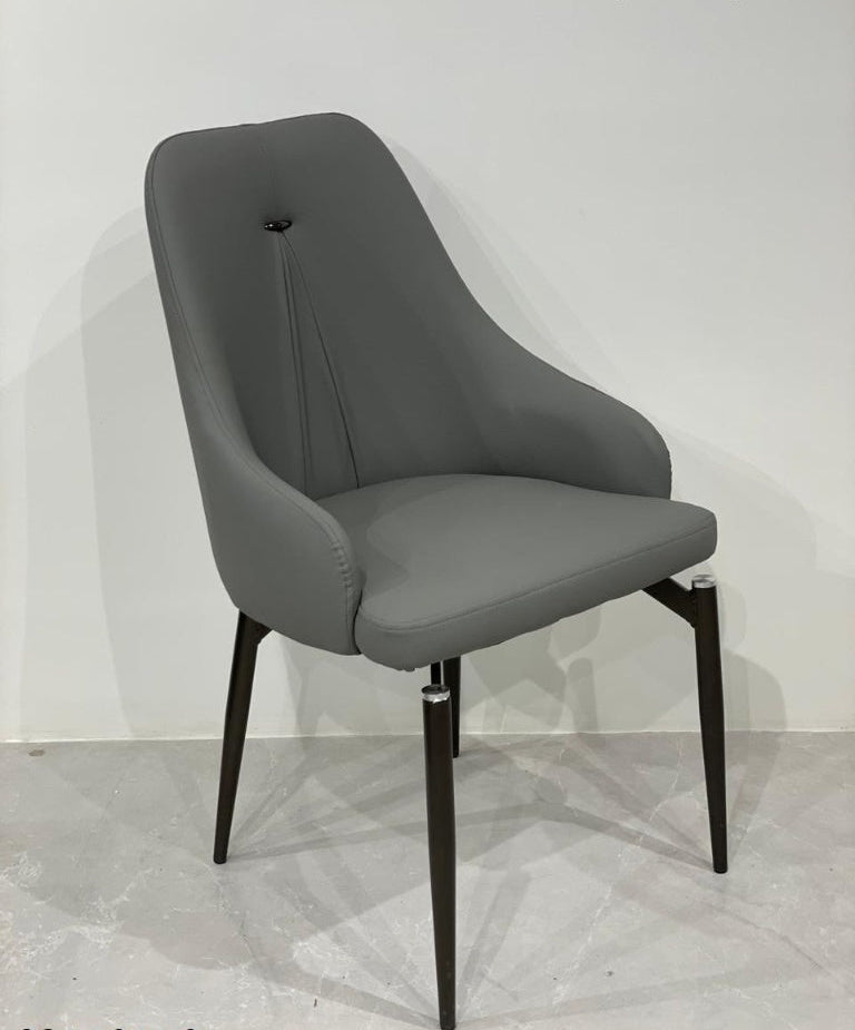 Dark grey dining chair with black legs on a light gray floor.
