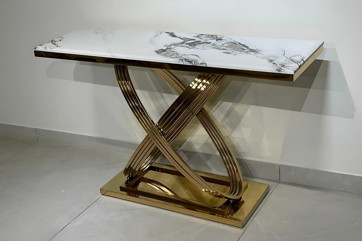 An elegant console table with a polished white marble top and a rose gold 'X' base.