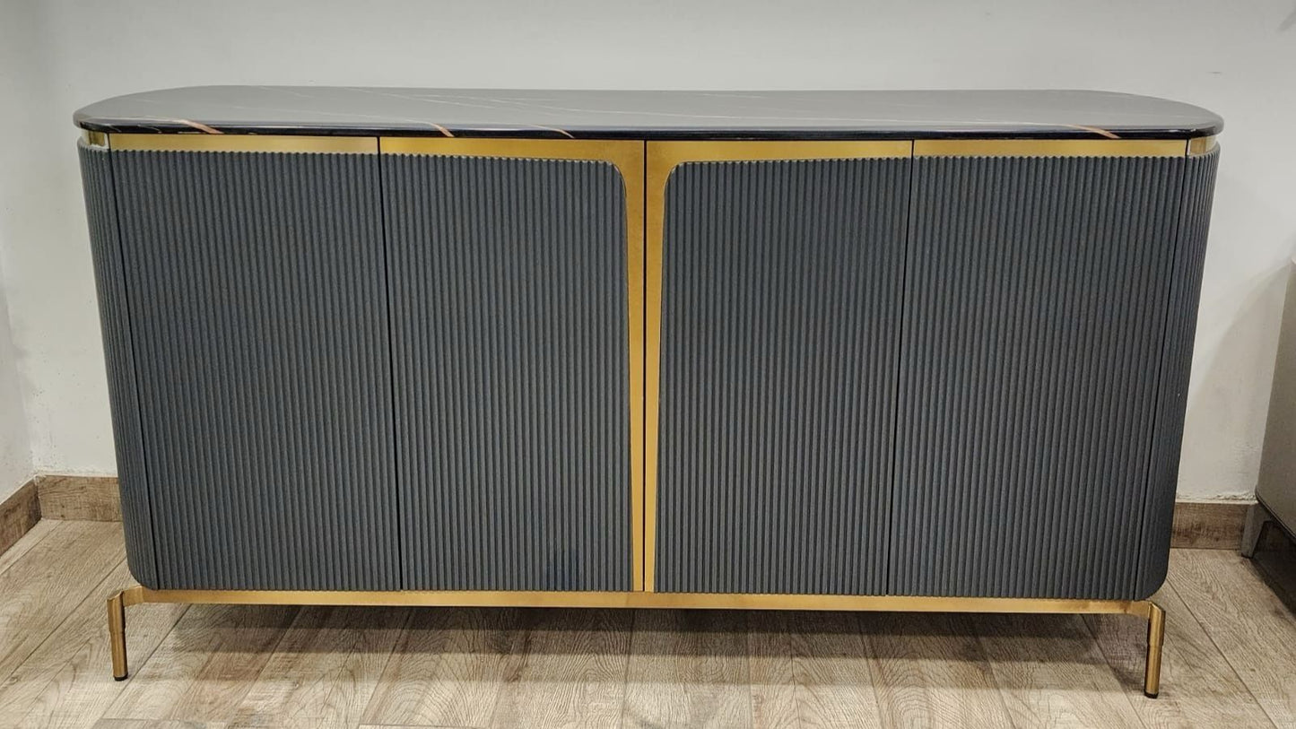 Gray sideboard with gold accents on a wooden floor against a white wall.