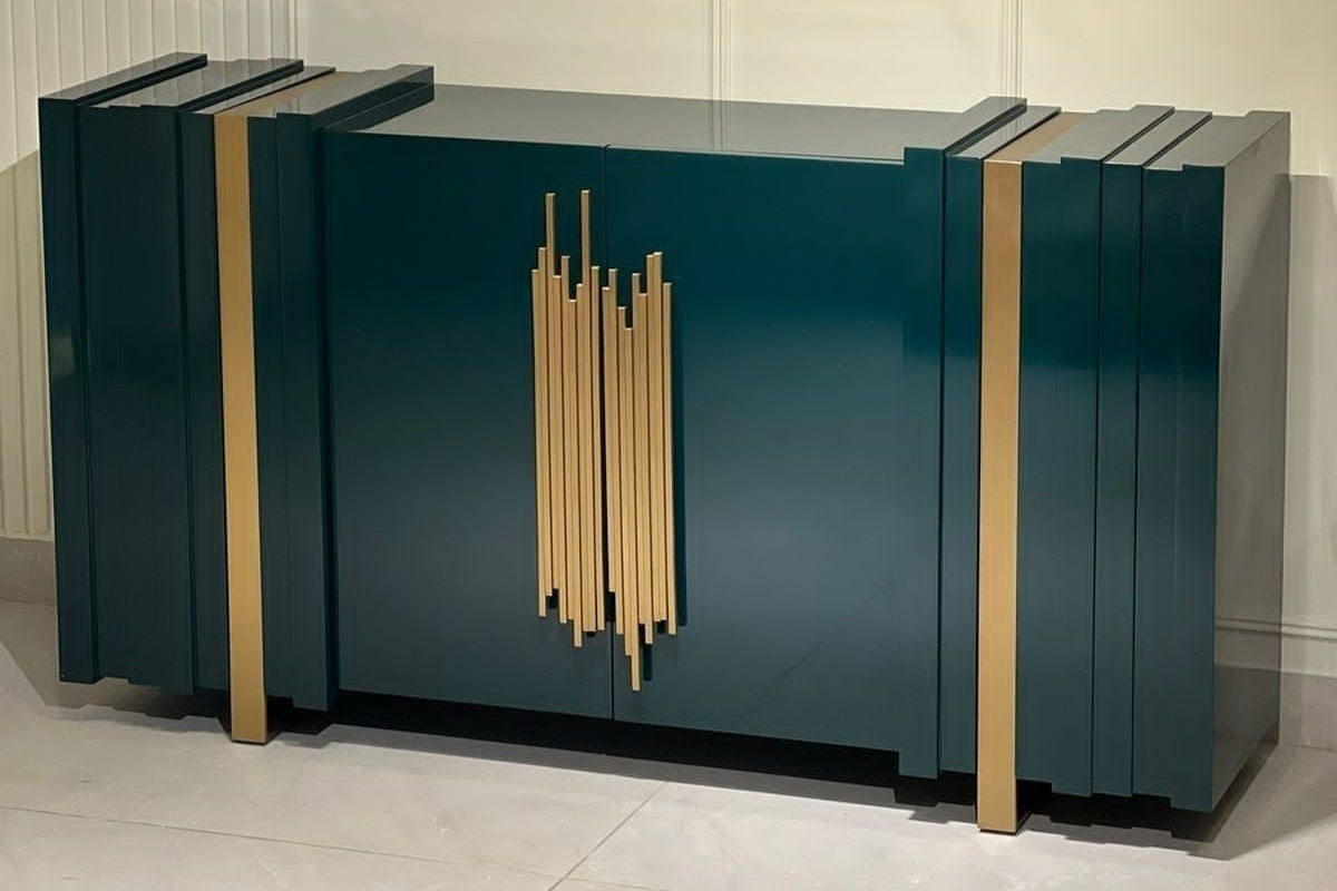 Modern green cabinet with gold accents on a light gray background