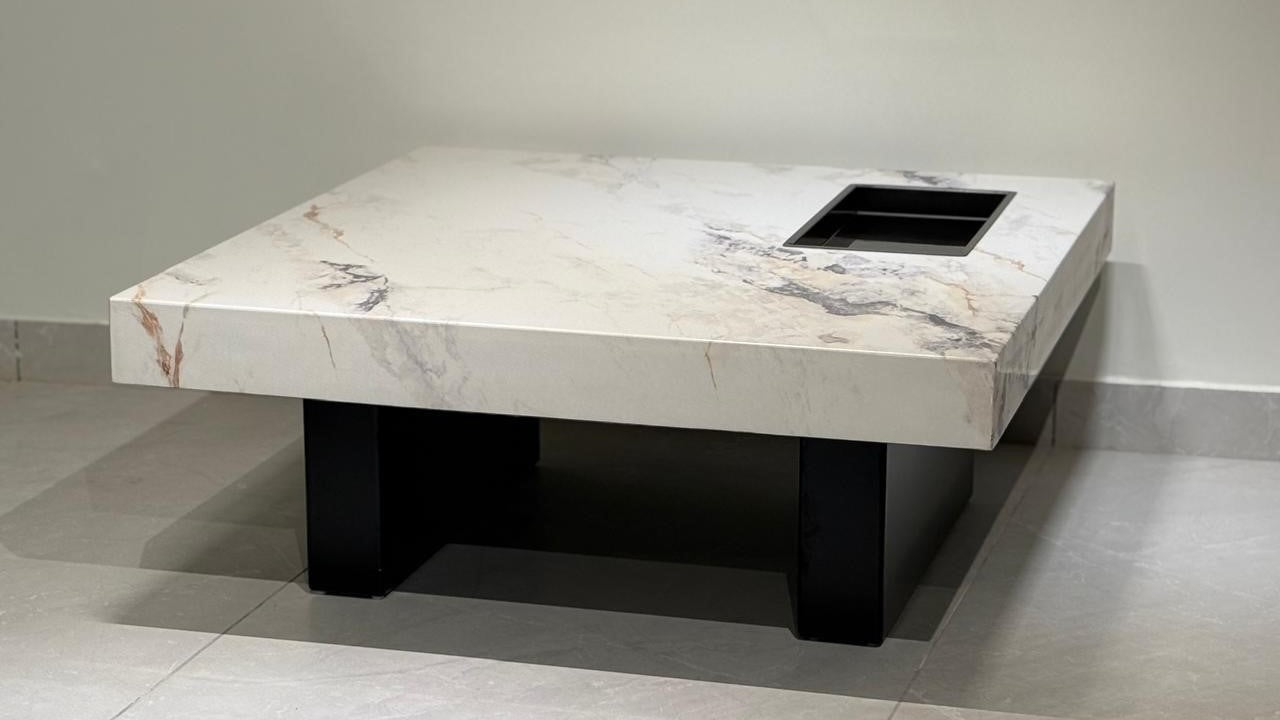 Luxury white Carrara marble coffee table with black legs and integrated tray.