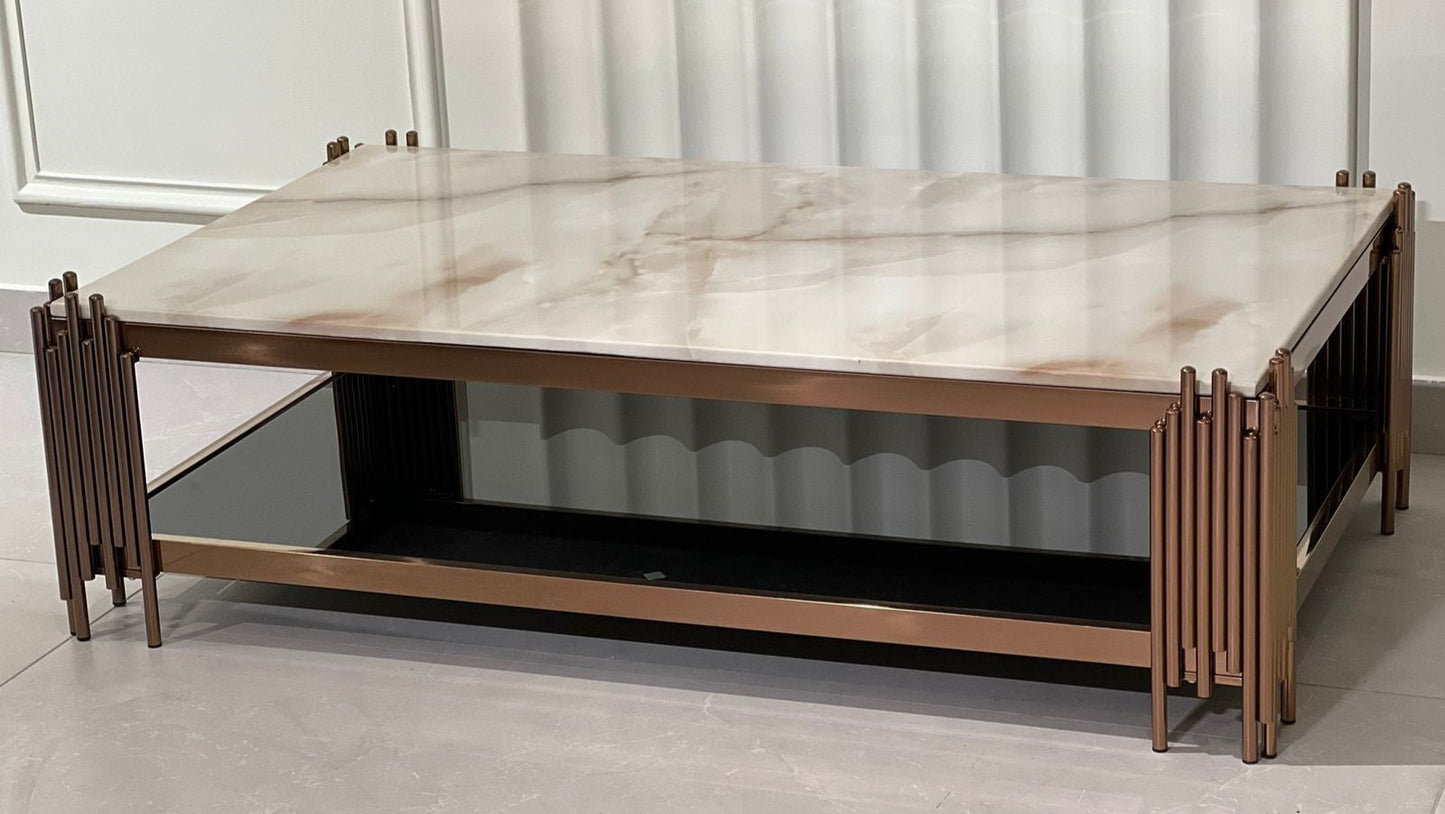 Rectangular rose gold coffee table with marble top and vertical accent legs in luxury setting