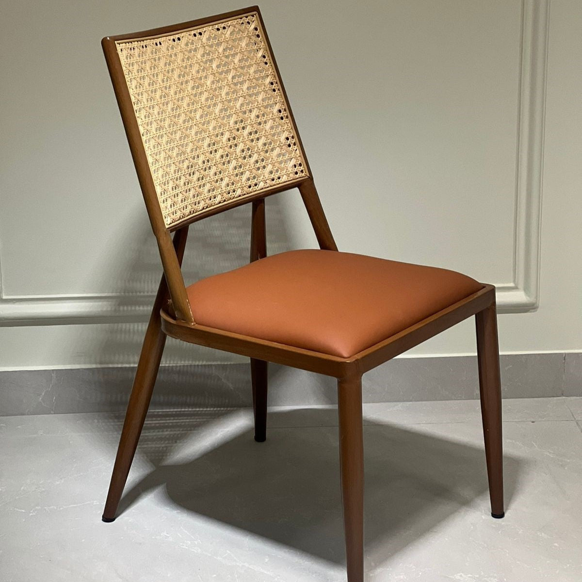 Modern brown upholstered chair with cane detailing