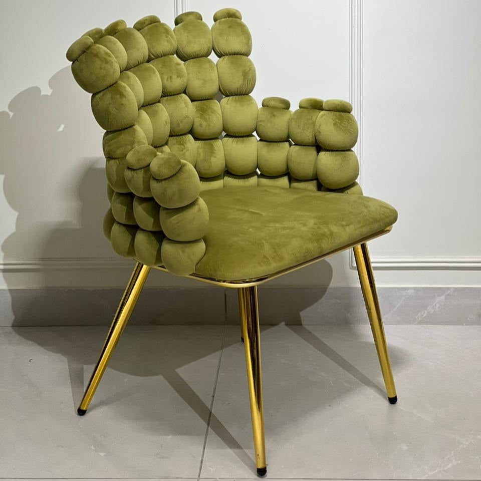 Green velvet accent chair with bubble-style backrest and gold legs