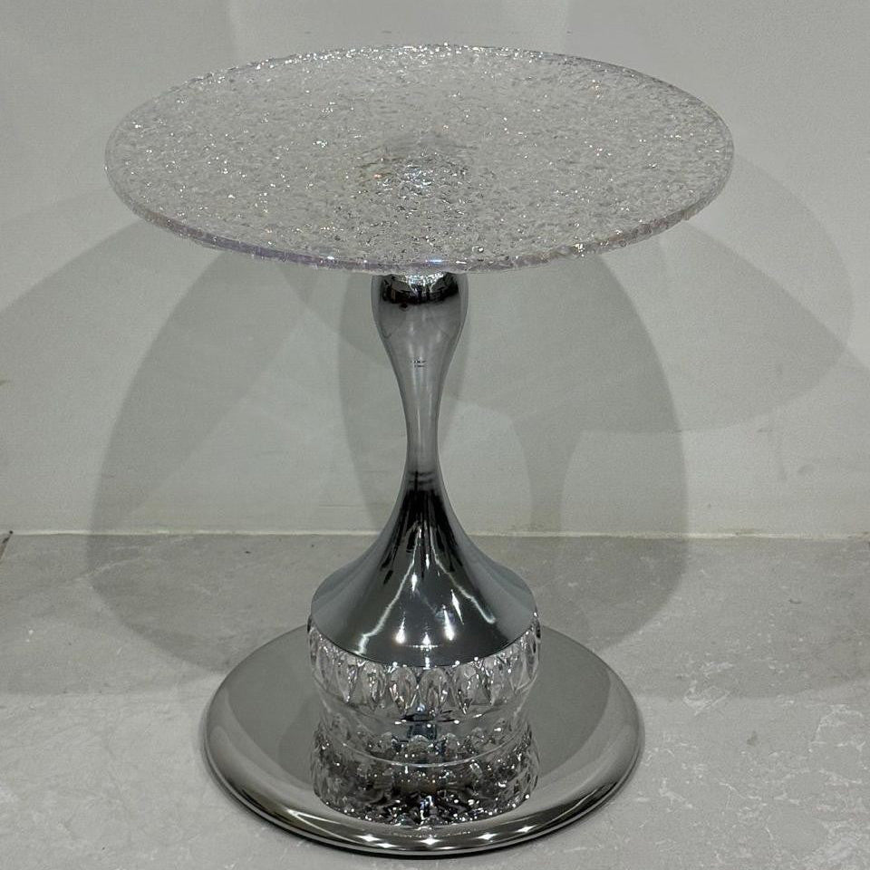 Silver side table with glittery top and base on a gray background