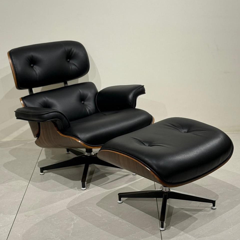 Black relax chair with stool on a light gray floor.
