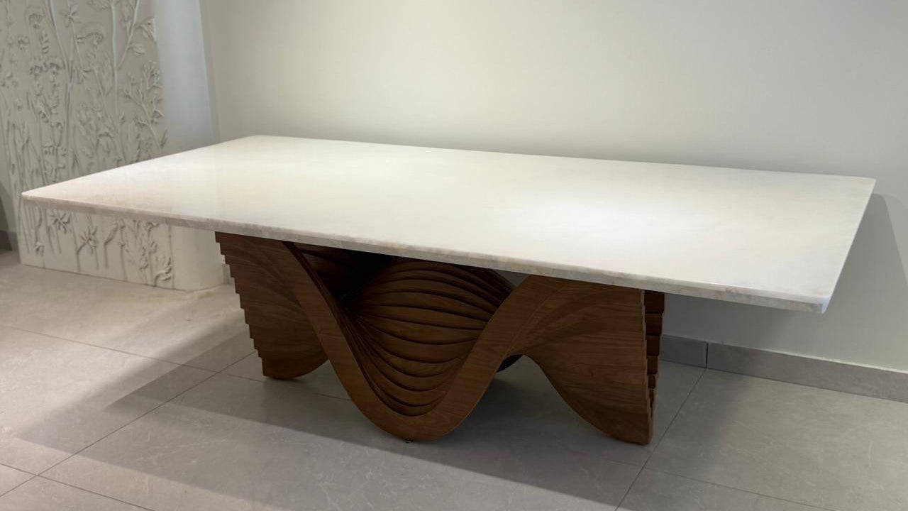Modern table with a white top and wooden base in a minimalistic setting