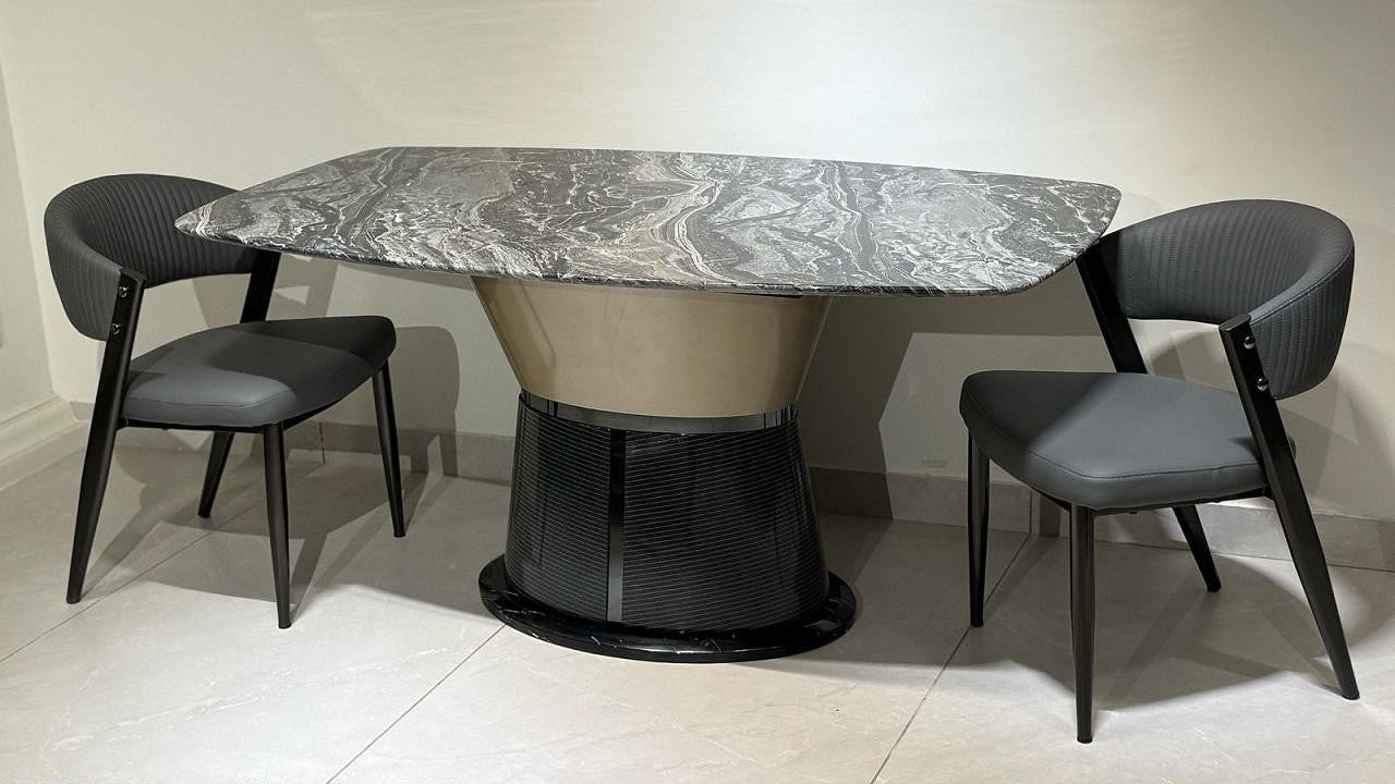 Dining table with marble top and four chairs in a minimalistic setting