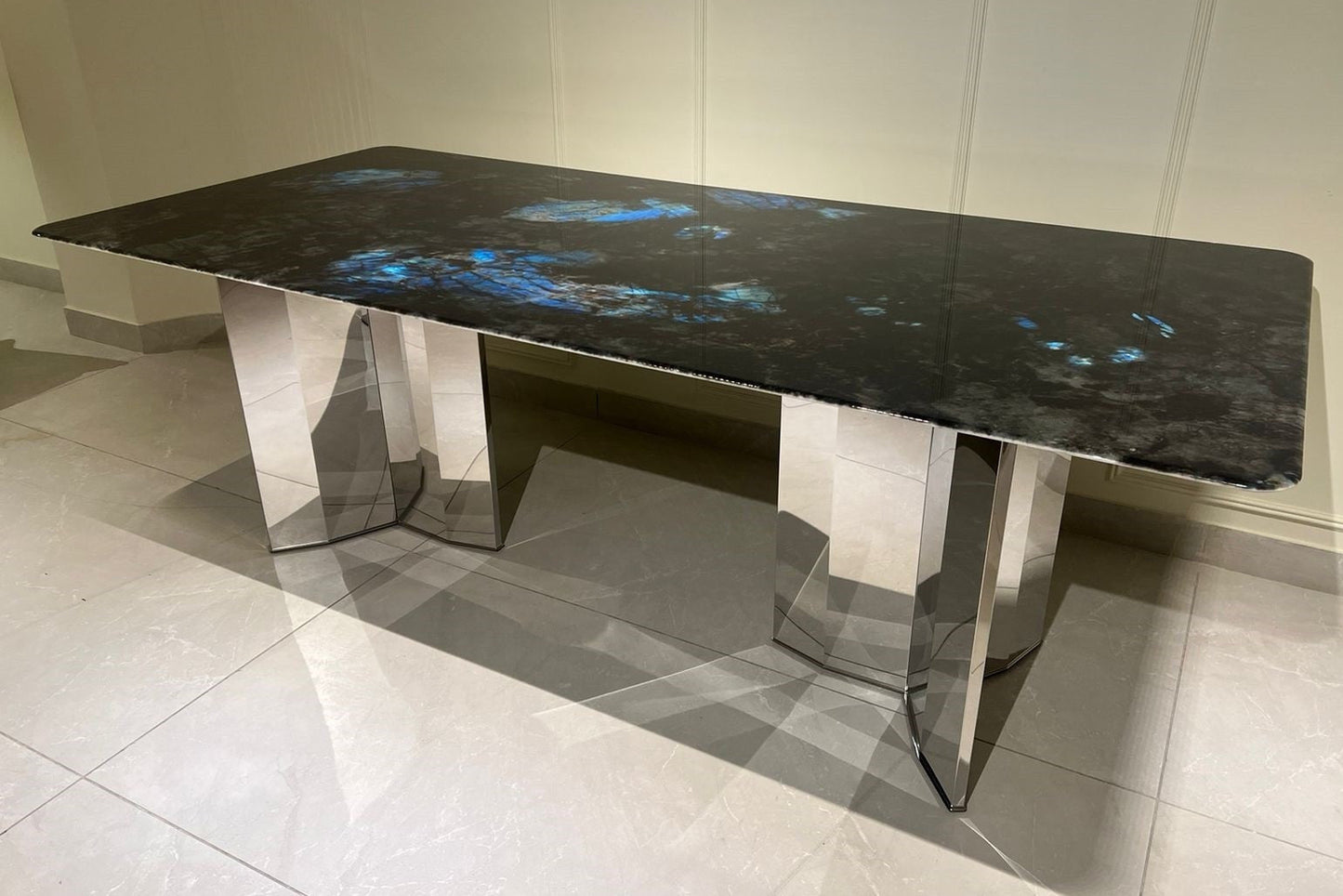 Starlume black marble dining table, faceted geometric polished metal base