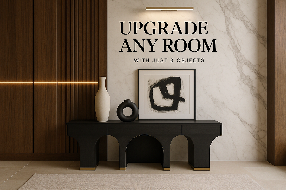 Venetian plaster wall in warm ivory with travertine paneling on the sides. Minimalist modern artwork centered on the wall. Below it, a marble console with a single sculptural vase and brass tray.