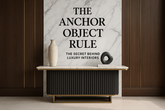 Luxury console styled with sculptural objects against marble and walnut wall — TAS Living.