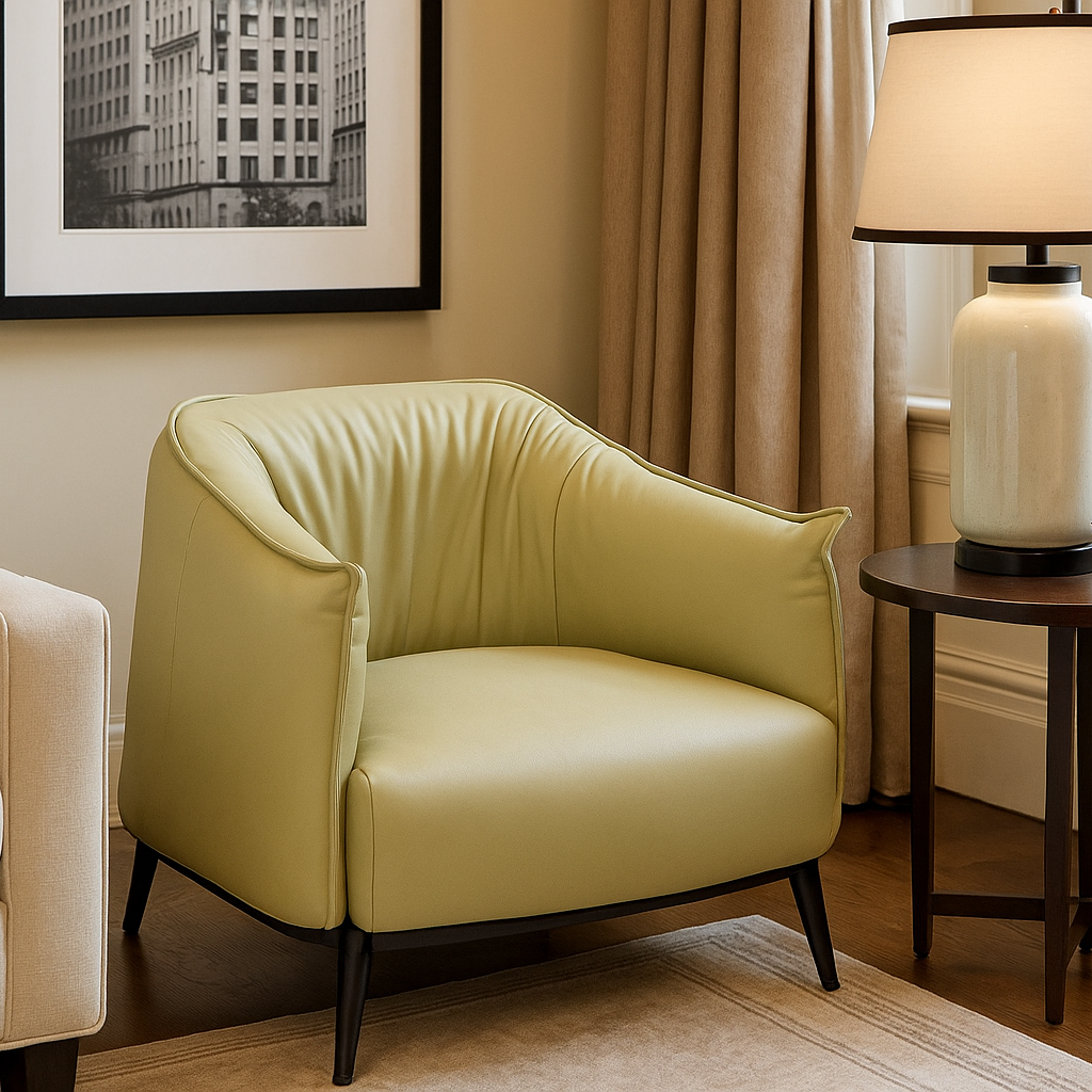 Light green armchair in a living room setting with a lamp and framed picture on the wall.