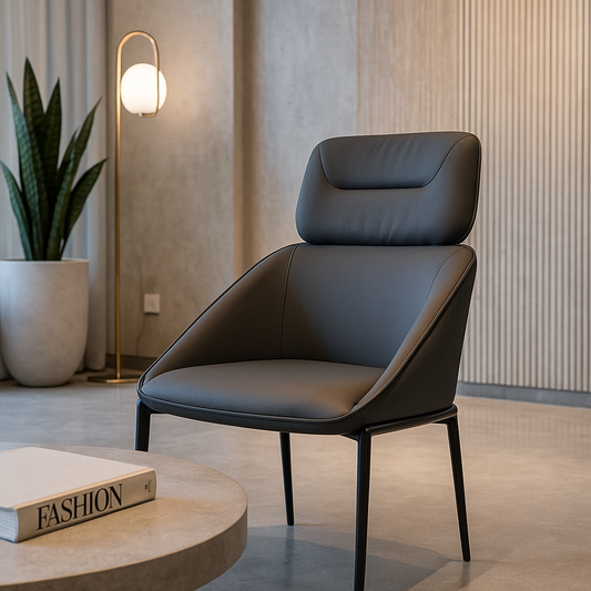 Modern gray chair in a stylish room with a plant and round table.
