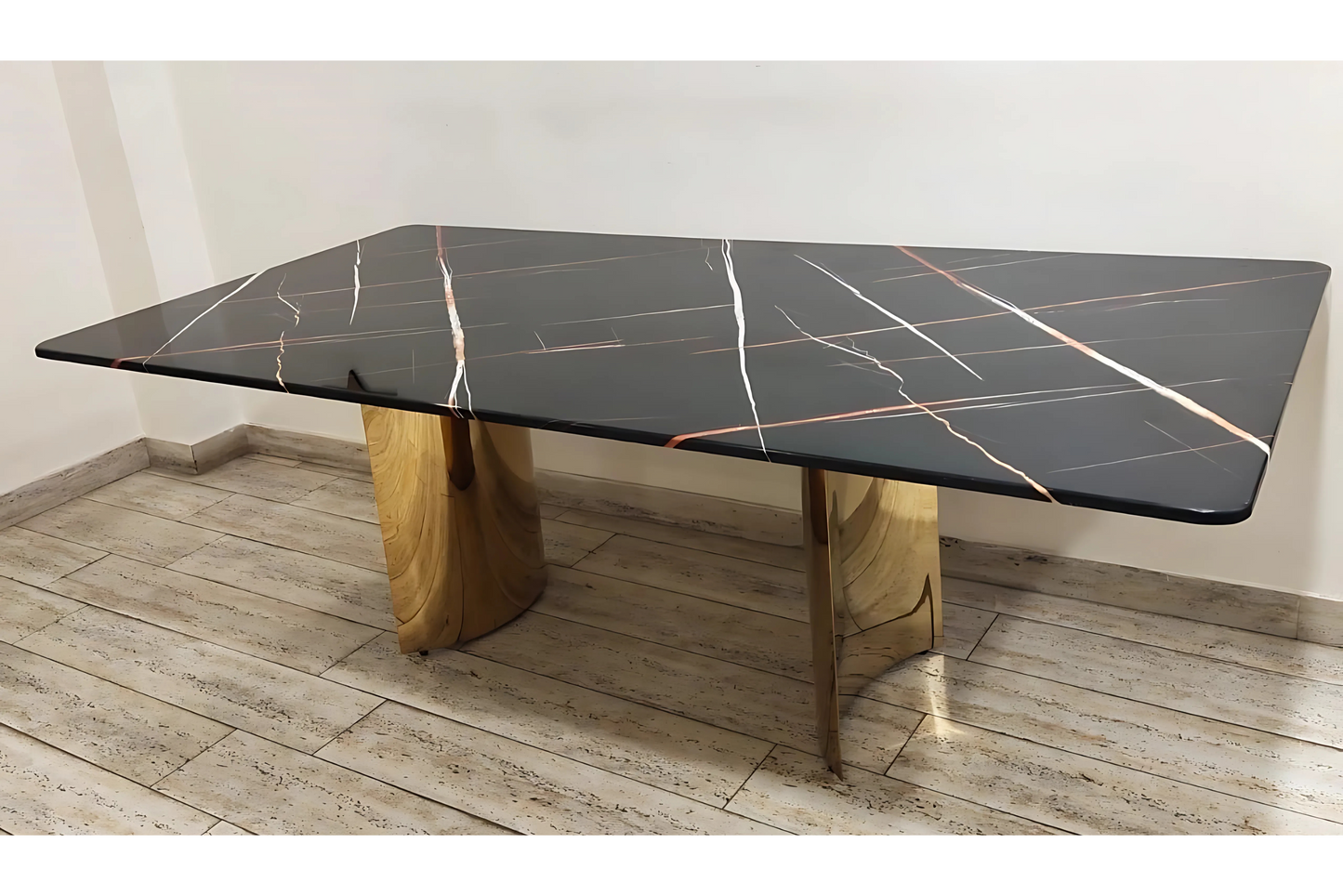 Luxury black dining table with copper-white marble veining and sculptural gold pedestal legs