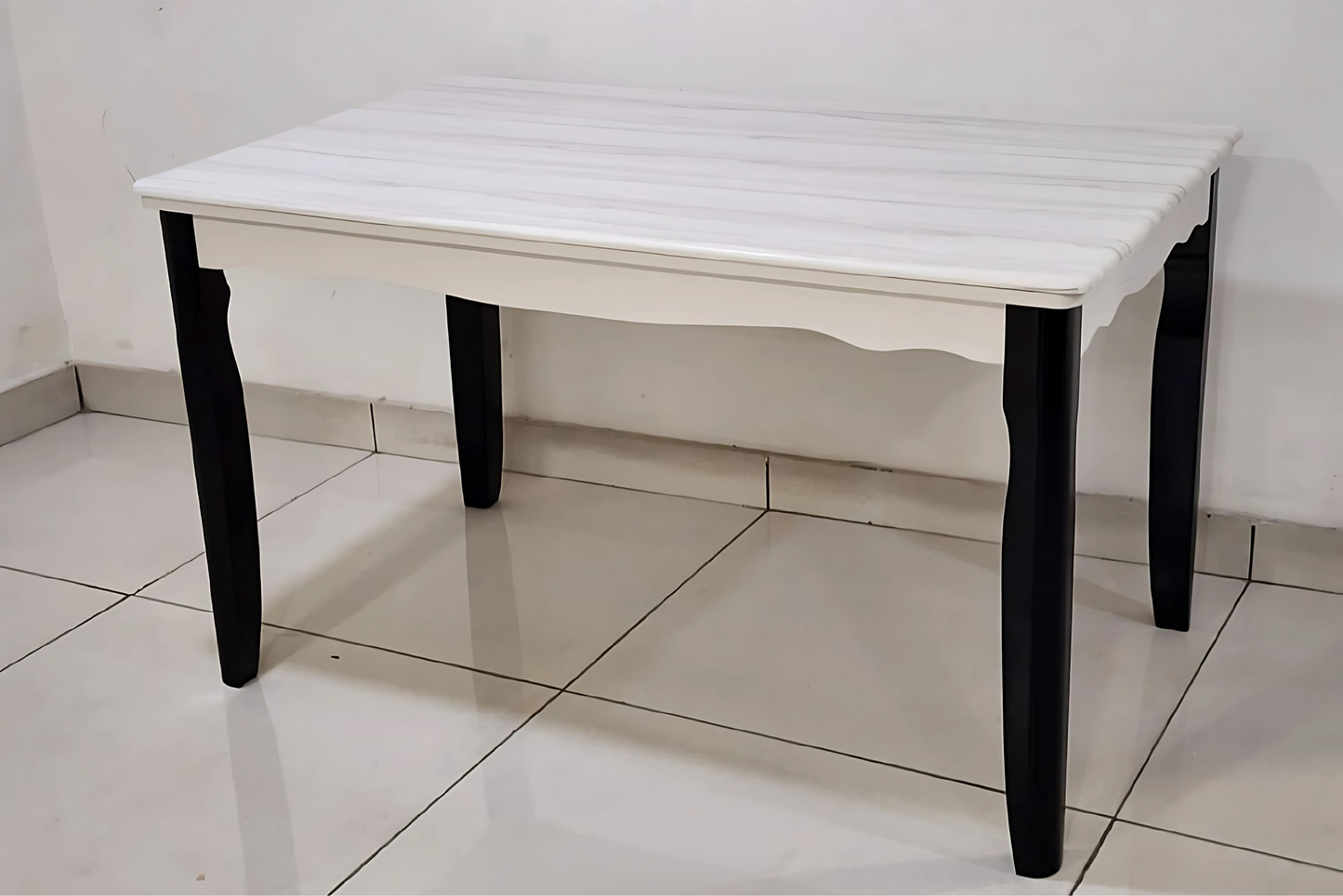 Ivory minimalist dining table with scalloped apron and dark curved legs in French classic style