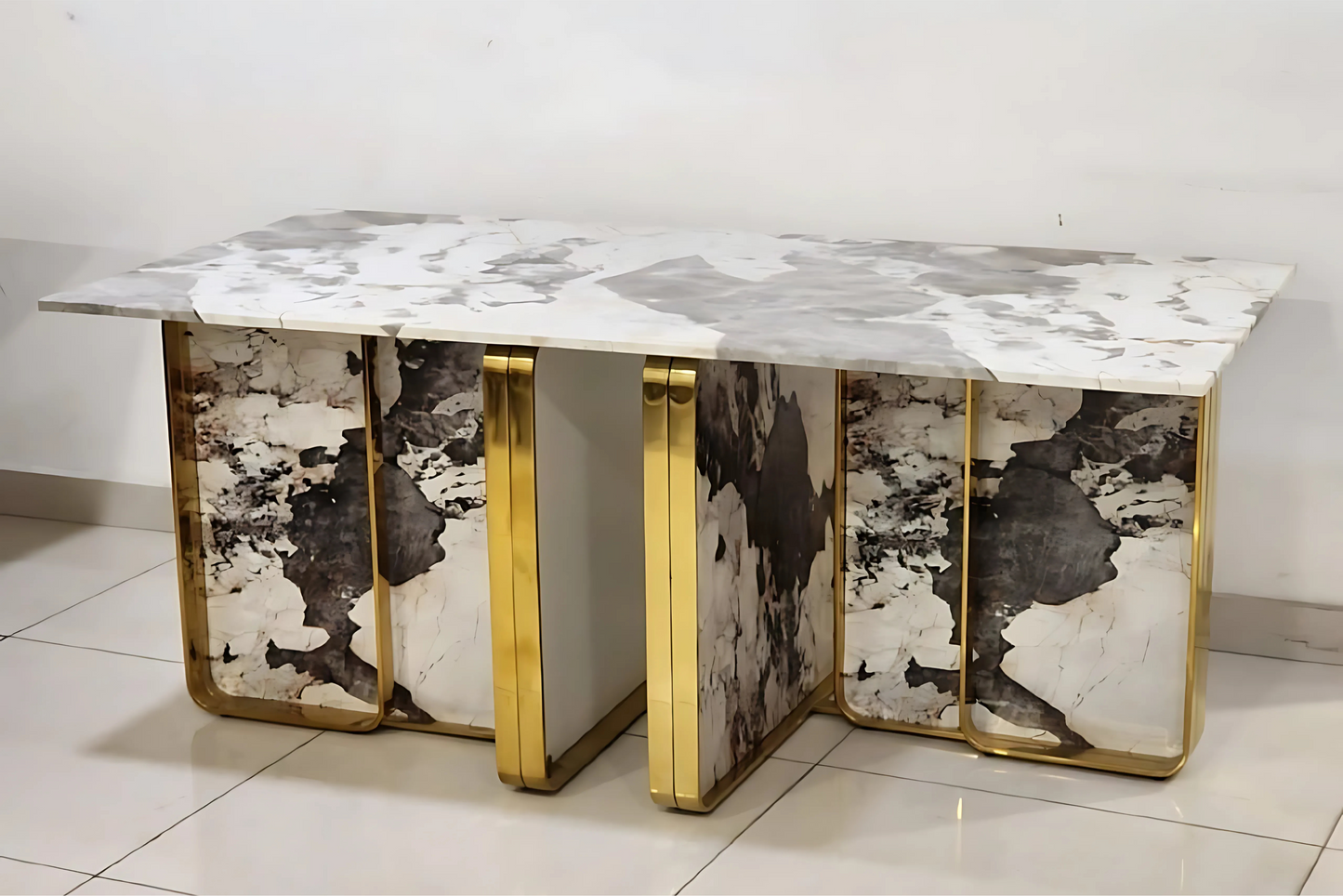 Luxury dining table with abstract marble base, gold frame, and veined marble top