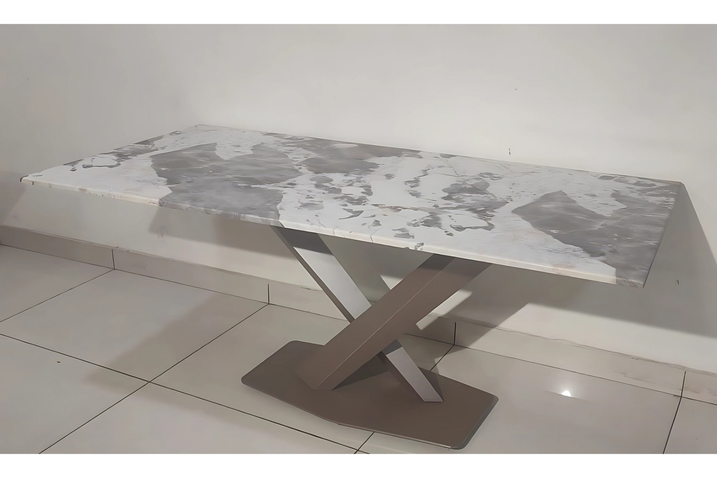 Modern X-base dining table with grey-white marble top and sculptural taupe metal pedestal